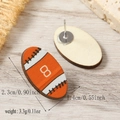 Macro shot showing front and back details of rugby-themed wooden stud earrings - Orange Digital Pattern