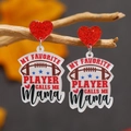 Detail view of football acrylic heart earrings with Mama text on a branch background - My Favorite Player Calls Me Mama Style (WEH4518)