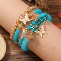 Detail of bohemian beaded bracelet set featuring blue acrylic beads and golden butterfly charms - Butterfly Pendant Style (WB316) / Light Blue
