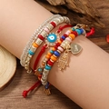 Close-up of Bohemian layered bracelets featuring Hamsa hand and Evil Eye charms - Hamsa Hand And Evil Eye Style (WB313) / Colorful