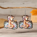 Artistic giraffe and floral wooden dangle earrings hanging on a natural tree branch - Multicolor Giraffe