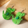 Detail of green marble acrylic crocodile earrings with gold outlines on woven background - Green Crocodile (WEH4717)