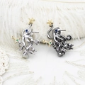 Macro shot of octopus brooches with emerald swords and gold stars on white feathers - 24*33mm / Gun Black Octopus