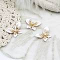 Macro shot of 18K gold plated butterfly pendants with white pearly wings and zircon center - Butterfly Design / White