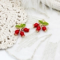 Detailed close-up of red strawberry charms with green leaves and 18K gold plated loops - Red Fruit Style / Red