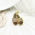 Close-up of gold-plated slipper pendants with colorful micro-pave stones on lace background - Rhinestone Slipper