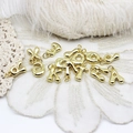 Macro detail of 3D bubble style golden alphabet pendants for DIY jewelry design - A-Z Set