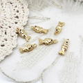 Macro shot of 18K gold plated fish charms with smooth polished finish for DIY jewelry - Fish