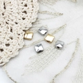 Detailed view of square gold and silver spacers for DIY jewelry necklace making - Gold Square