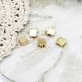 Macro shot of gold tulip flower spacer beads for DIY jewelry making on lace background - Tulip