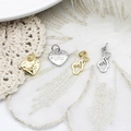 Detail view of heart tags and finger heart charms in gold and silver plating on white lace - Gold Letter Heart (11.2*11.7mm)