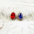 Close-up of 18K gold plated oval pendants with red and blue crystals and zircon edges - Red Oval with Zirconia Ring (12*19.2mm)
