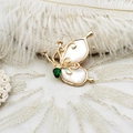 Detailed macro view of the butterfly brooch with white shell wings and green gemstone - 35*35mm / Green Zircon Mother of Pearl Butterfly