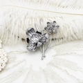 Macro shot of lily of the valley brooch with inlaid cubic zirconia and pearl petals - 41*53mm / Full Zircon Double Flower