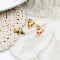 Macro detail of three enamel pizza slice charms with golden rings on lace background - Brown And Green Pizza Style