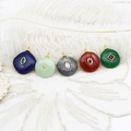 Detail of five geometric semi-precious stone pendants with 18K gold plated brass settings - Round Malay Jade