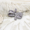 Macro shot of a silver bow brooch with pavé-set pink and white cubic zirconia stones - Full Zirconia Pink Bow Knot Style (G0543) / 30.5*37.5mm