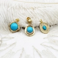 Macro detail of turquoise pendants with gold plating and cubic zirconia inlays - Pockmarked Oval Style