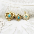 Detailed macro view of vintage turquoise heart and round gold DIY jewelry pendants - Large Hollow Heart Style