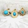 Detailed macro shot of vintage 18K gold turquoise pendants on white lace background - Multi Layer Oval Style