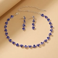 Detailed view of wave-style silver necklace and drop earrings with dark blue crystals - Sapphire Blue