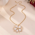 Detail of flower pendant necklace with gold twisted chain and white enamel petals - White Necklace