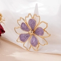Detailed macro view of golden flower ring with purple marble enamel on a white cone stand - Light Purple / Light Purple