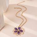 Detail of gold rope chain necklace with a purple flower pendant and lobster clasp - Purple Necklace