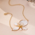 Detail of gold floral anklet with white enamel petals and adjustable lobster clasp - White