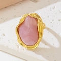 Macro detail of French vintage irregular gold ring with a large pink baroque resin stone - Pink
