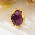 Macro detail of French vintage ring featuring purple baroque stone and gold pleated metal - Purple