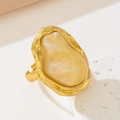 Macro detail of French vintage baroque ring with irregular amber-tone stone and gold texture - Yellow