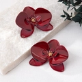 Exquisite deep red orchid flower earrings with golden center on marble background - Burgundy