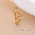 Macro view of gold snake-shaped non-piercing nose clip with detailed scale texture - Snake