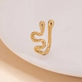 Macro shot of gold snake-shaped non-piercing nose clip with polished metal texture - Snake