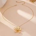 Detail van een gouden bloem hanger ketting met getextureerde bloemblaadjes op O-ketting - Ketting