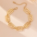 Detailed close-up of golden Greek key pattern bracelet with adjustable lobster clasp - Bracelet