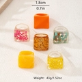 Detail view of colorful geometric resin rings with gold foil and stone inlays for women - Multi-Color Assortment