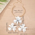 Detail view of large white 3D flower pendant necklace with size labels and gold choker - White Zirconia Set