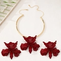 Detailed macro view of an oversized red iris floral pendant and matching stud earrings - Wine Red Set