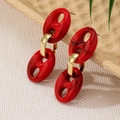 Close-up of red marble resin earrings with gold oval link on a rustic display - Marbled Red Style (E0139) / Red