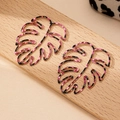 Golden Monstera leaf earrings with pink and black leopard pattern on wooden stand - Leopard Hollow (E1429-Magenta) / Rose Red