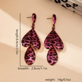 Detail view of pink leopard print earrings with dimensions 8.4cm length and 2.8cm width - Rose Red