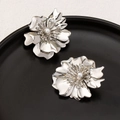 Elegant silver flower earrings with multi-layer petals and a pearl center on black tray - Small / Silver