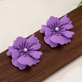 Close-up of matte purple flower earrings with white pearl centers on rustic wood - Small / Taro Purple