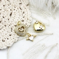 Three gold heart pendants with diamonds and wings on white lace and feather background - Wing Heart (8x12mm)