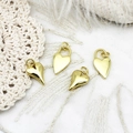 Polished 18K gold heart charms with twisted loop details on white lace and feather background - Small Heart