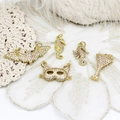 Macro shot of micro-paved zircon animal pendants on white lace fabric for jewelry making - Full Zirconia Bat