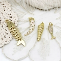 Gold marine pendants set featuring fish bone, seashell, and micro-paved gems on lace fabric - Long Conch
