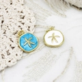 Macro shot of blue and white enamel starfish pendants with gold plated alloy edges - Blue Starfish